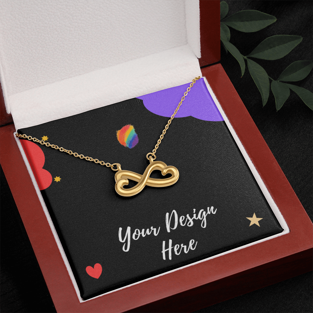 Gold infinity heart necklace displayed in open red jewelry box with custom design card