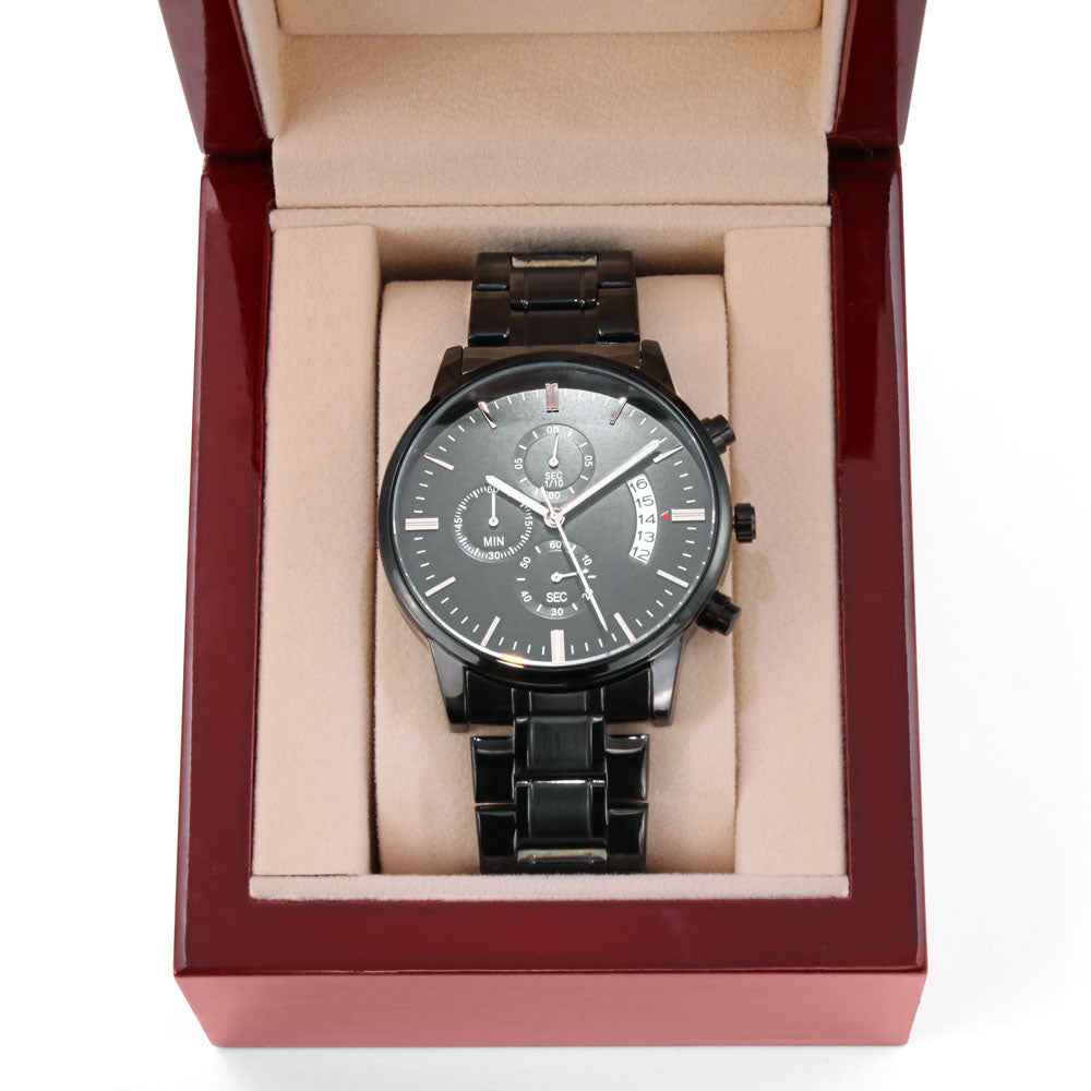 Black stainless steel wristwatch with chronograph and date display in red and beige cushioned wooden box