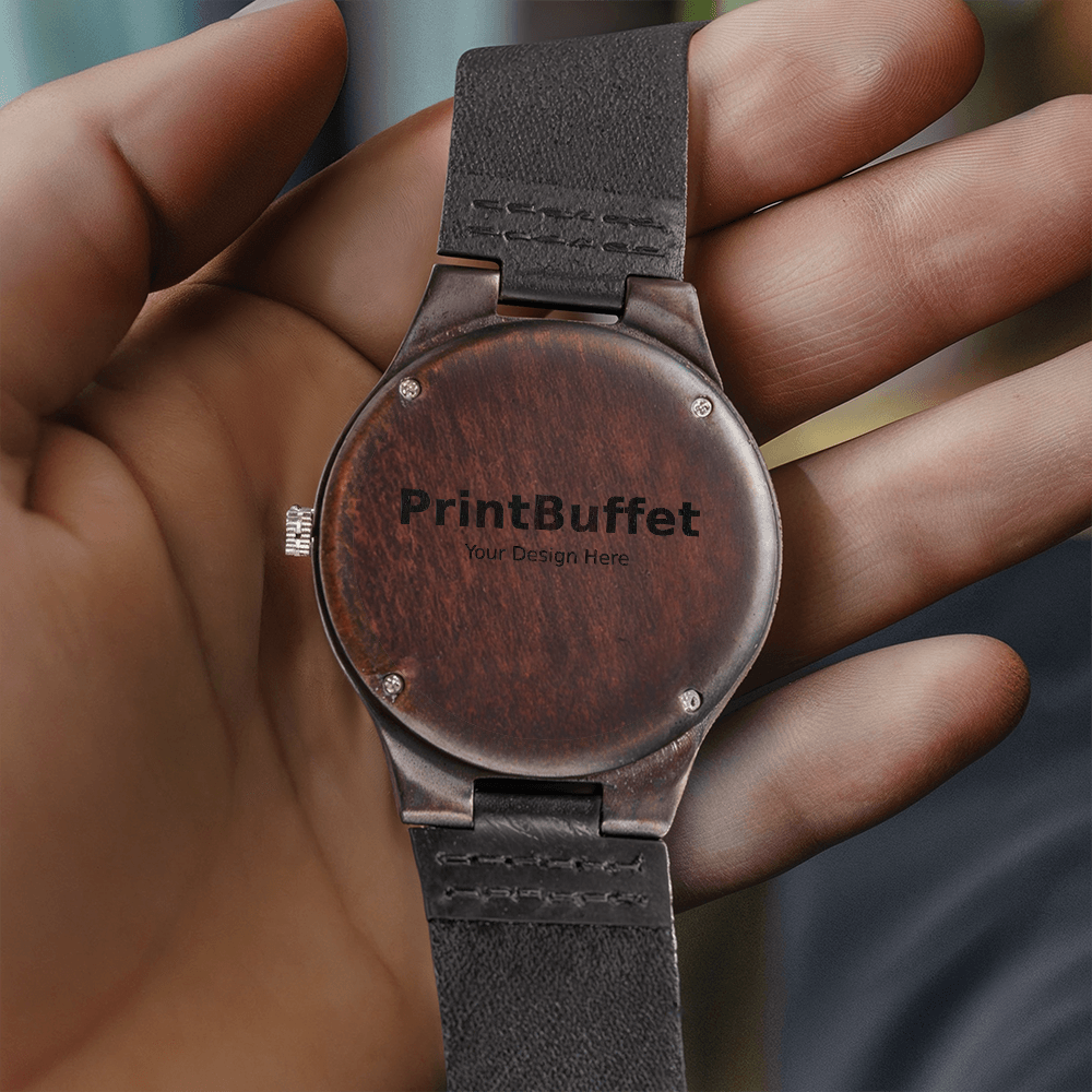Hand holding wooden watch back with black leather strap and PrintBuffet logo