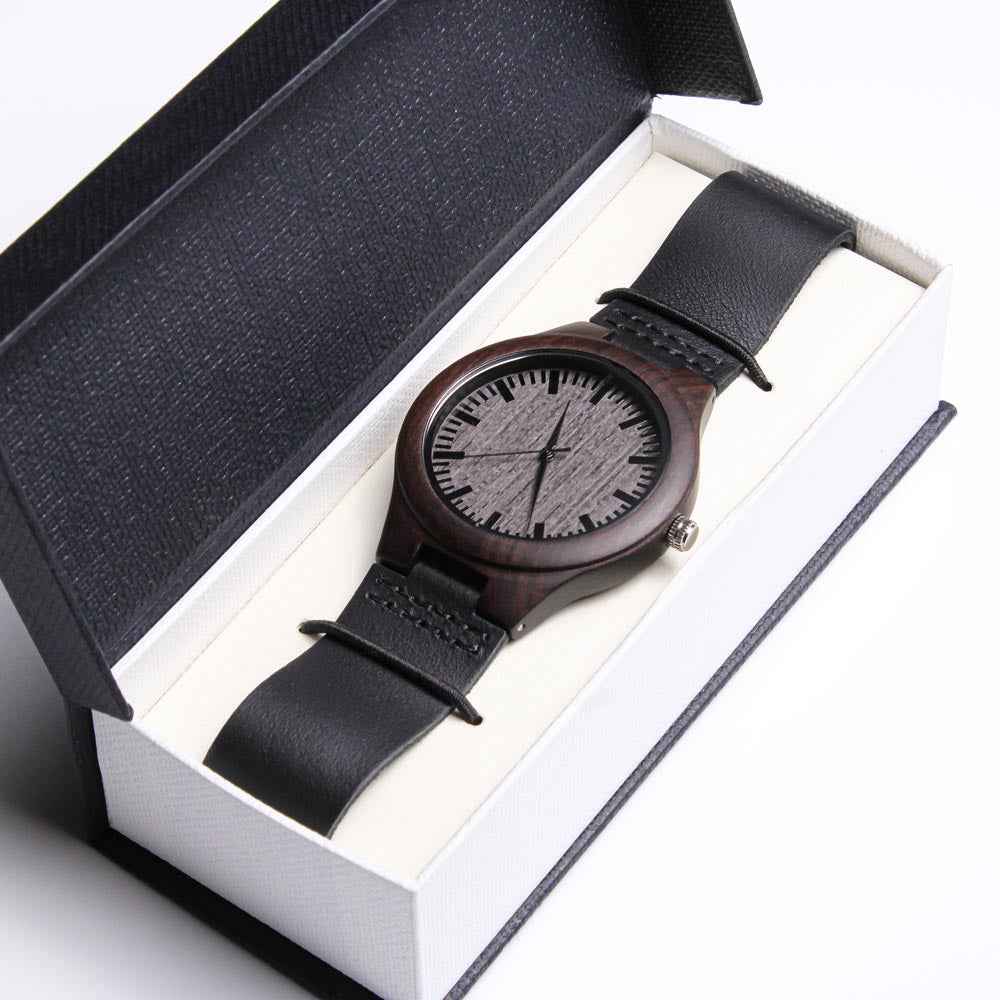 Minimalist wristwatch with wooden case and black leather strap in elegant black and white gift box