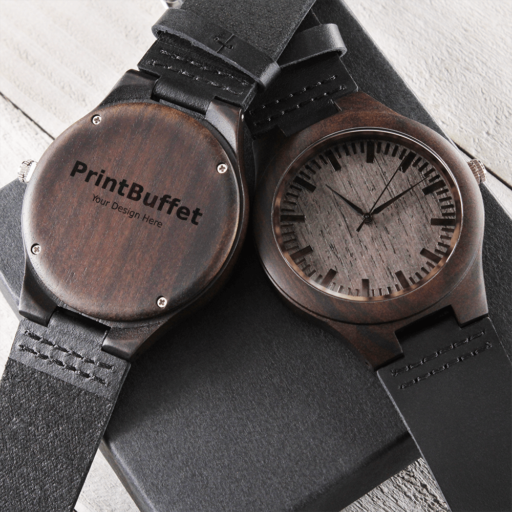 Wooden wristwatch with black leather strap showing front clock face and engraved back cover with PrintBuffet logo