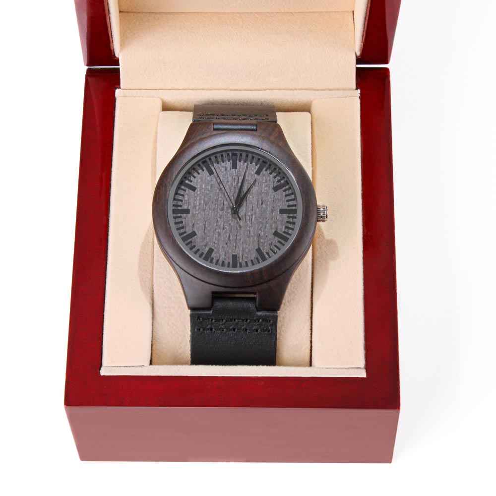 Dark wooden wristwatch with black leather strap in red velvet-lined display box