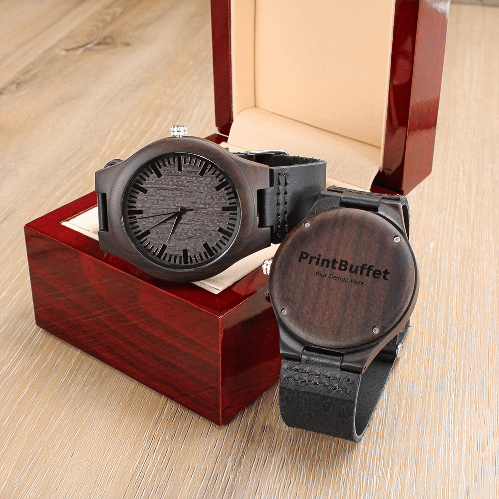 Wooden wristwatch with black leather strap displayed in an open red wooden box on a wooden surface