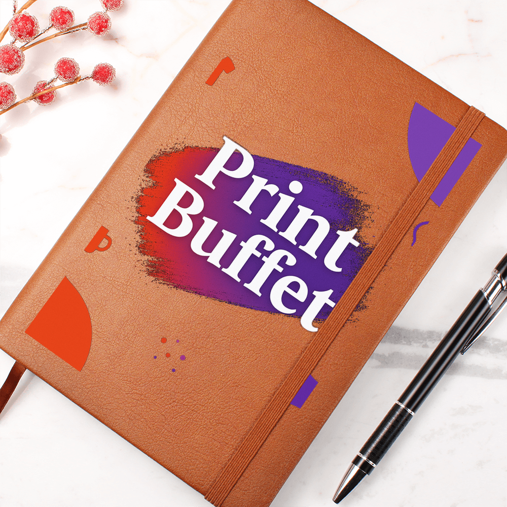 Brown leather notebook with Print Buffet logo and decorative orange and purple shapes, black pen on marble surface