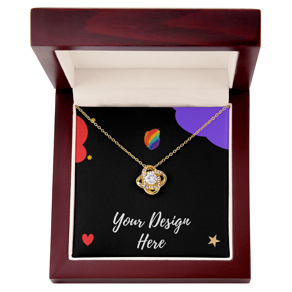 Gold pendant necklace with central crystal and smaller stones in wooden jewelry box with black insert