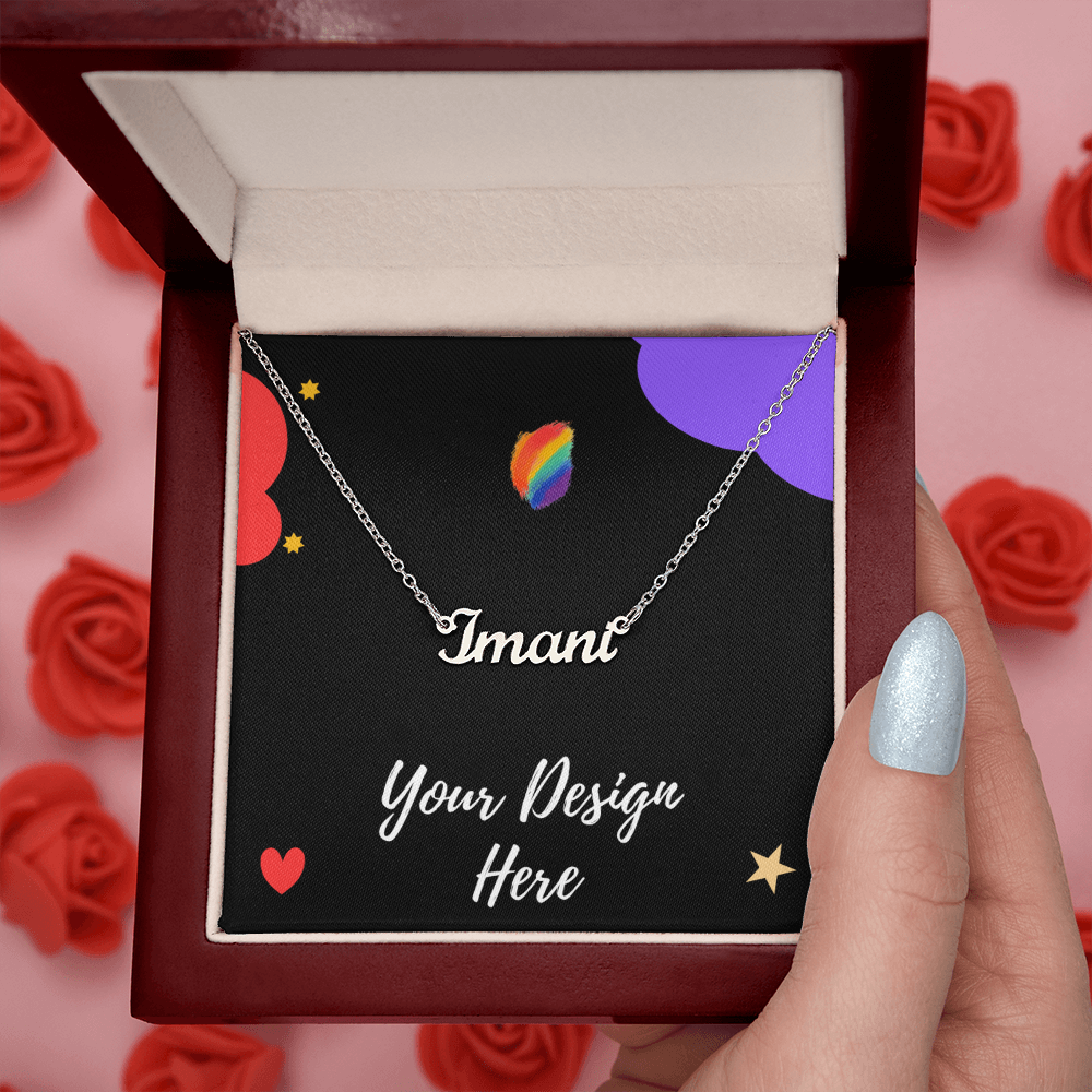 Silver name necklace with 'Imani' in red gift box, black card with colorful hearts and stars, hand holding box