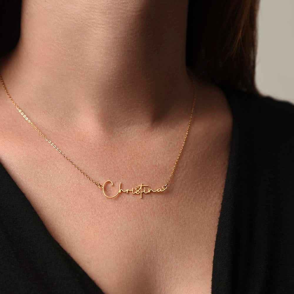 Close-up of a woman wearing a delicate gold name necklace reading Christina on her neck