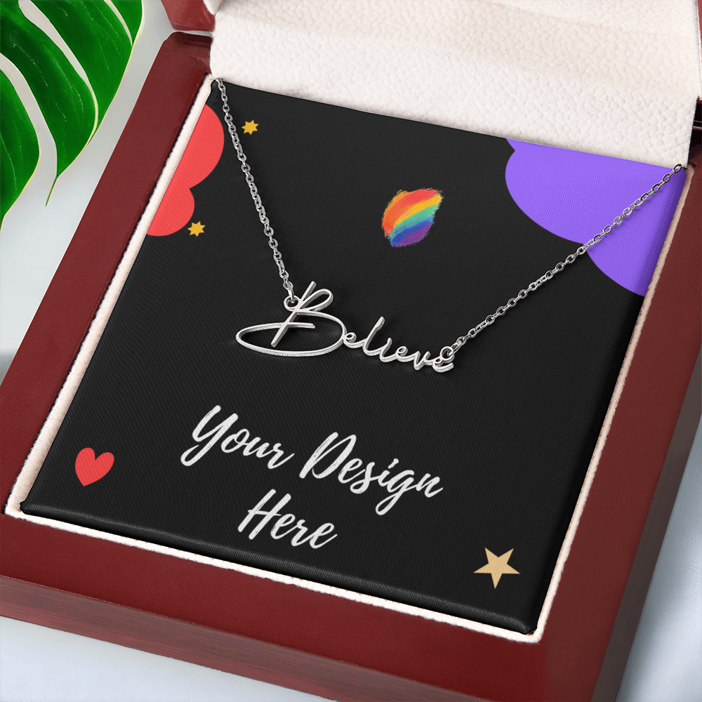 Silver 'Believe' necklace in custom gift box with colorful design and green leaf background