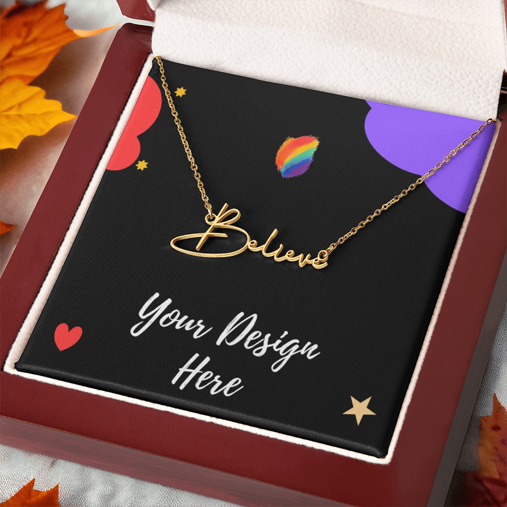 Gold 'Believe' necklace displayed in a red gift box with colorful design background and autumn leaves