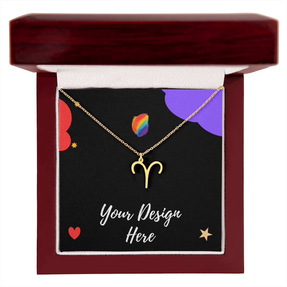 Gold Aries zodiac necklace in open dark red wooden jewelry box with colorful design card