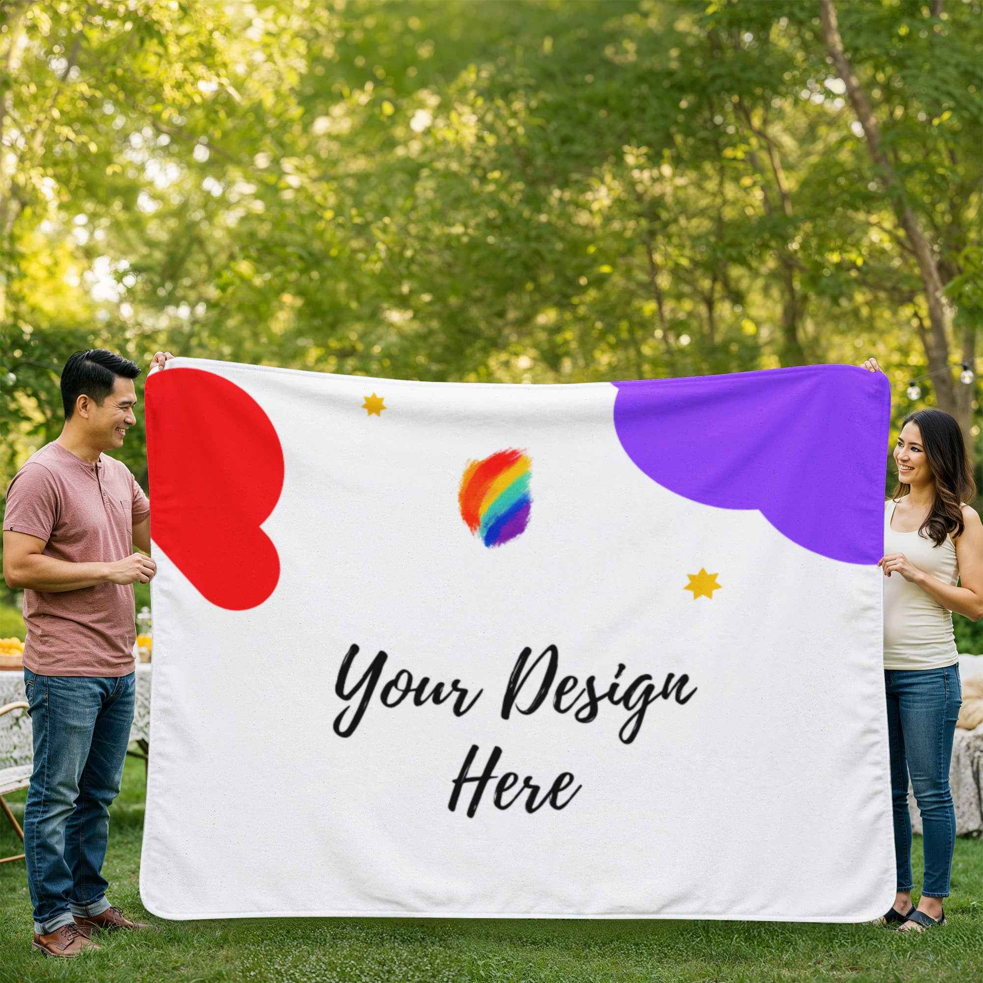 Man and woman holding a custom white blanket with red and purple shapes and text Your Design Here in a green park