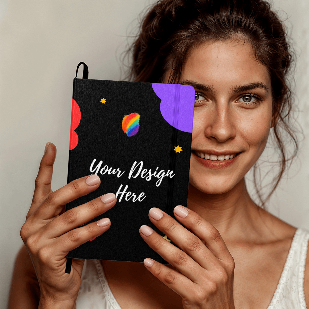Smiling woman holding black notebook with colorful abstract design and Your Design Here text