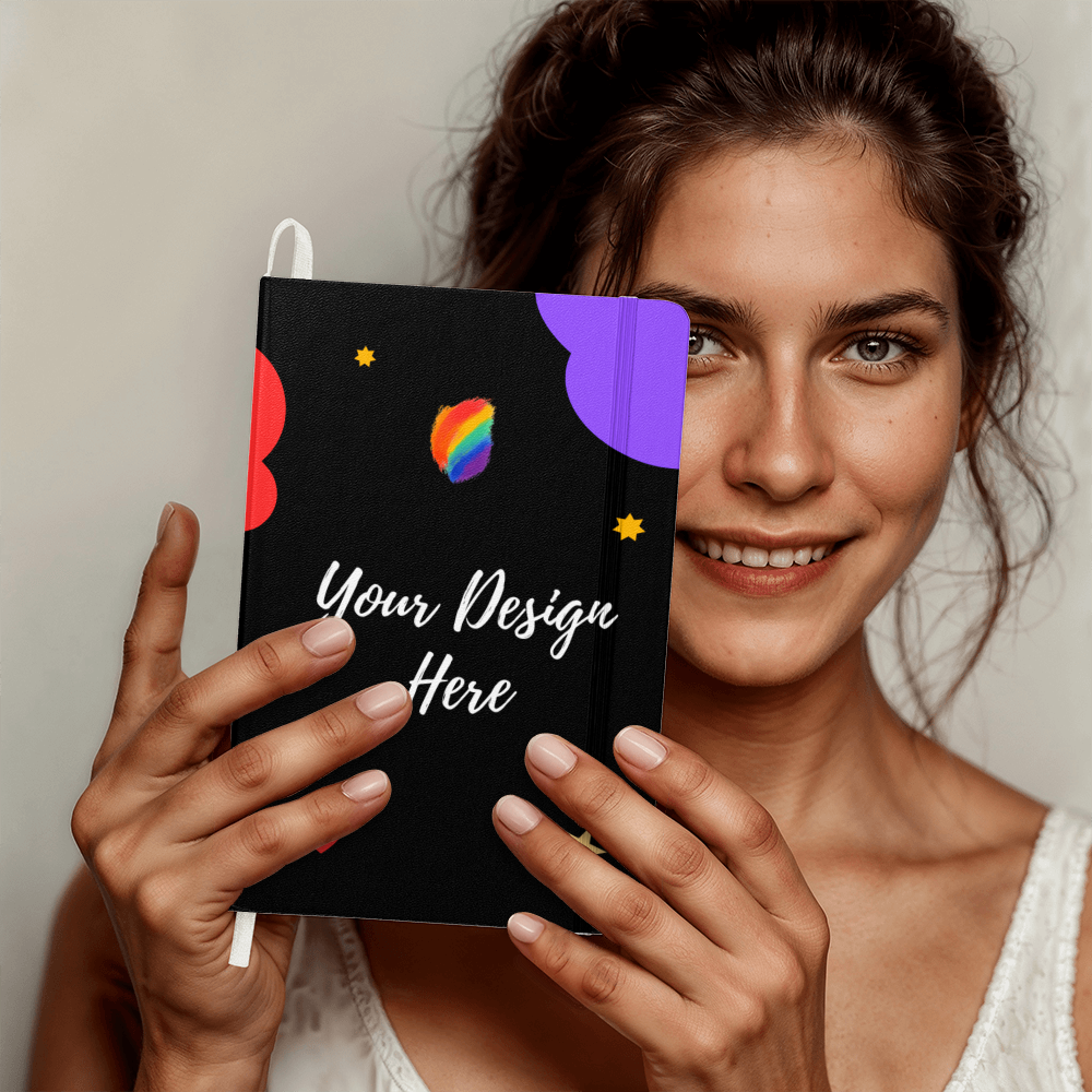 Smiling woman holding black notebook with colorful abstract design and text 'Your Design Here'