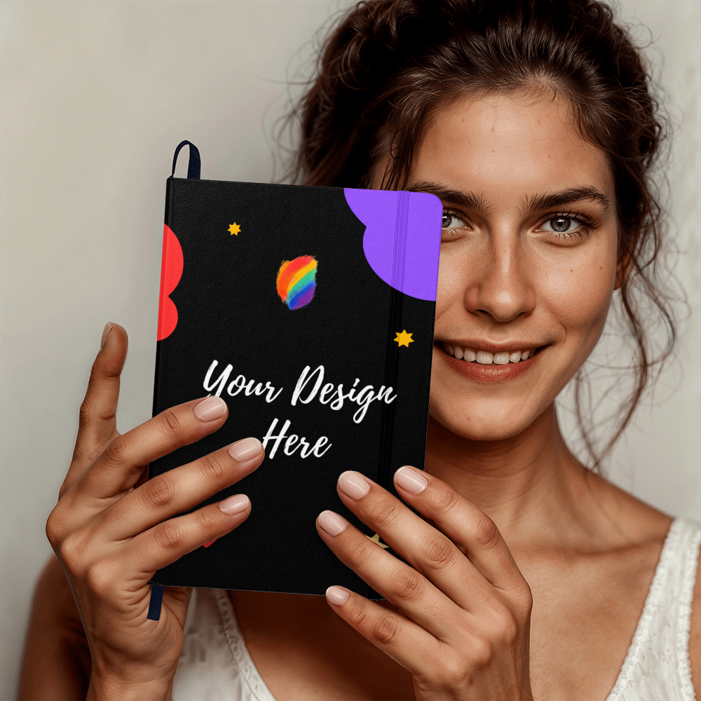 Smiling woman holding a black notebook with colorful shapes and text Your Design Here
