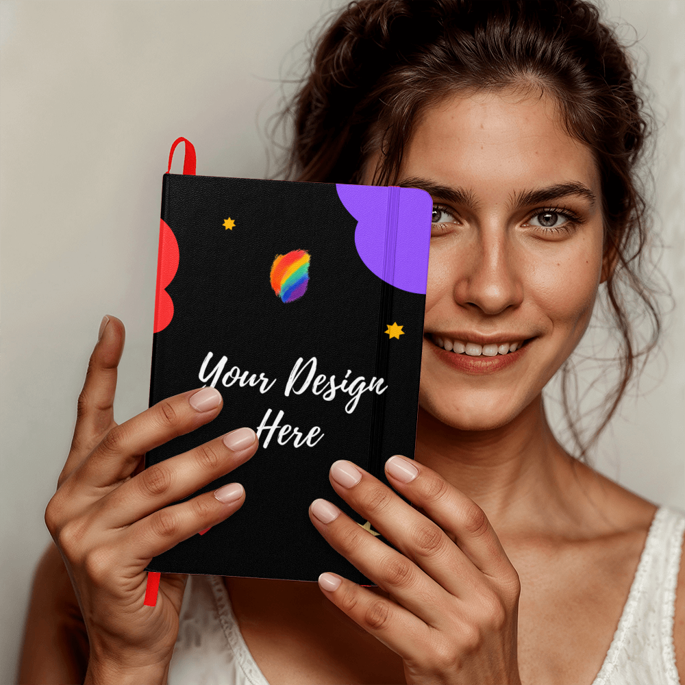 Smiling woman holding black customizable notebook with colorful abstract design and Your Design Here text