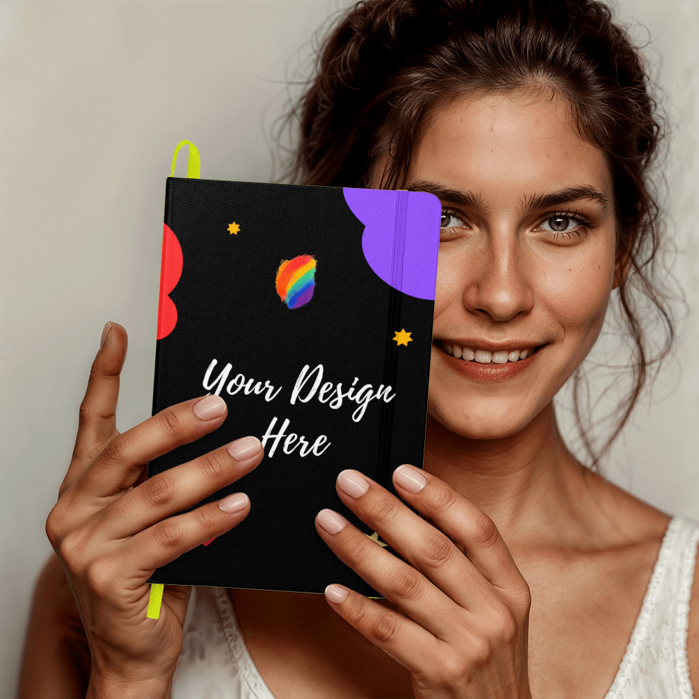 Smiling woman holding black notebook with colorful design and text Your Design Here