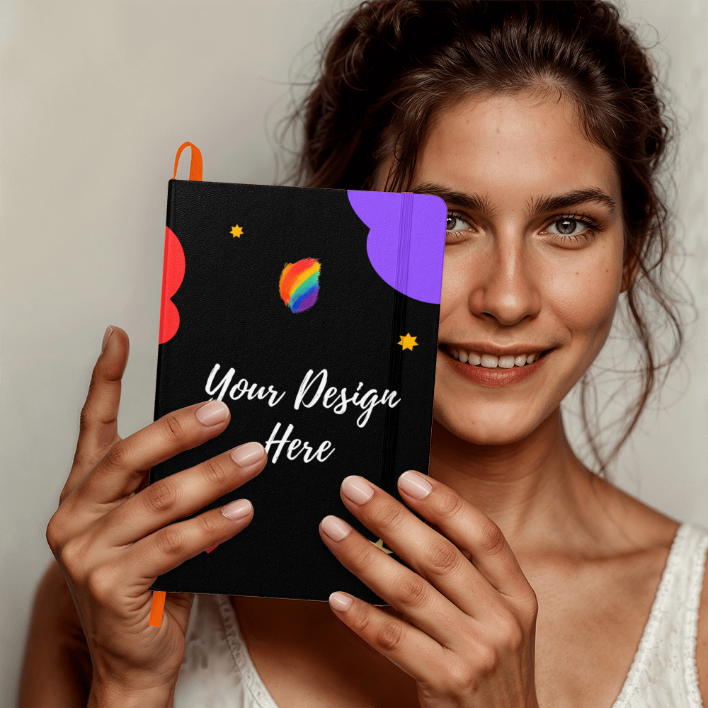 Smiling woman holding a black notebook with colorful abstract shapes and text Your Design Here