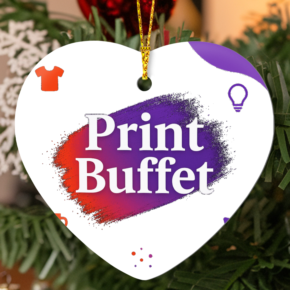 Heart-shaped Christmas ornament with Print Buffet logo in red and purple brush stroke hanging on tree