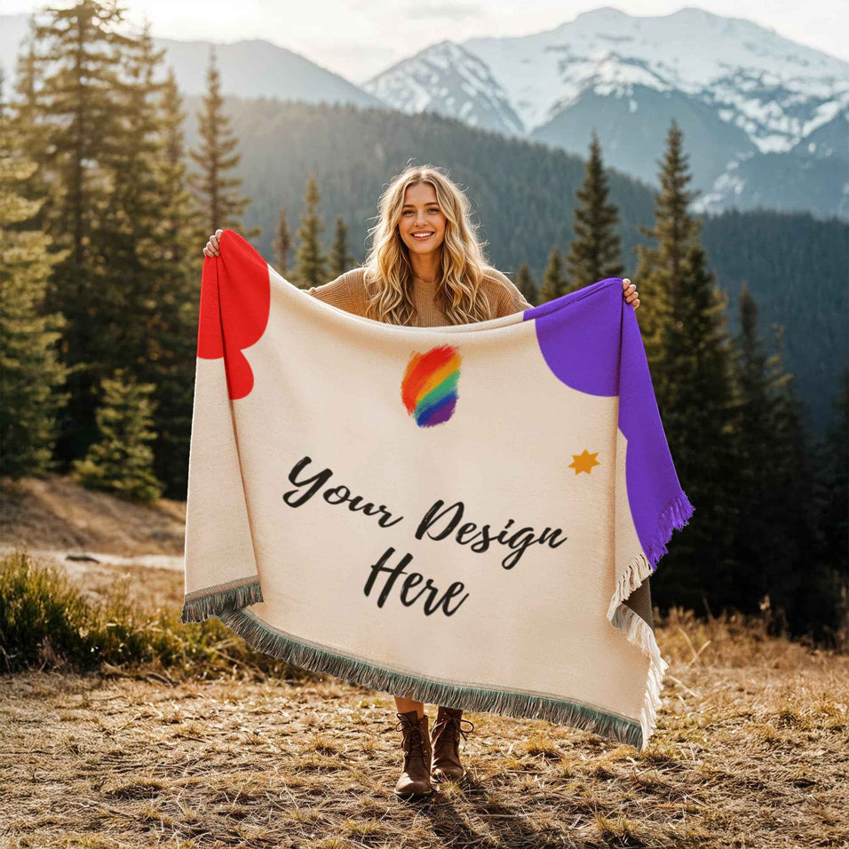 Smiling woman outdoors holding a customizable blanket with mountain and forest background